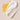 White cream and yellow oil on a beige background