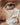 A close up of rich, thick, moisturizing cream being applied on a woman's face.