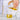 Hand pouring yellow liquid from a glass container into a beaker with a graduated cylinder nearby.