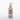 White bottle of cleansing milk with a pump on a white background