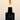 Black Botanical Recovery Serum dropper bottle with floral design on a beige background