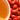 Close-up of red rose hip buds with a blurred orange background